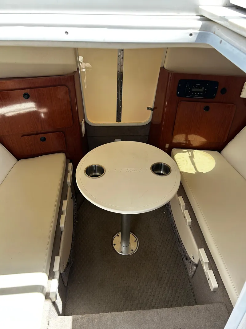 Slide: The Image of 2008 Ebbtide 2700 Cuddy Bow Rider interior with seating and table. - 20