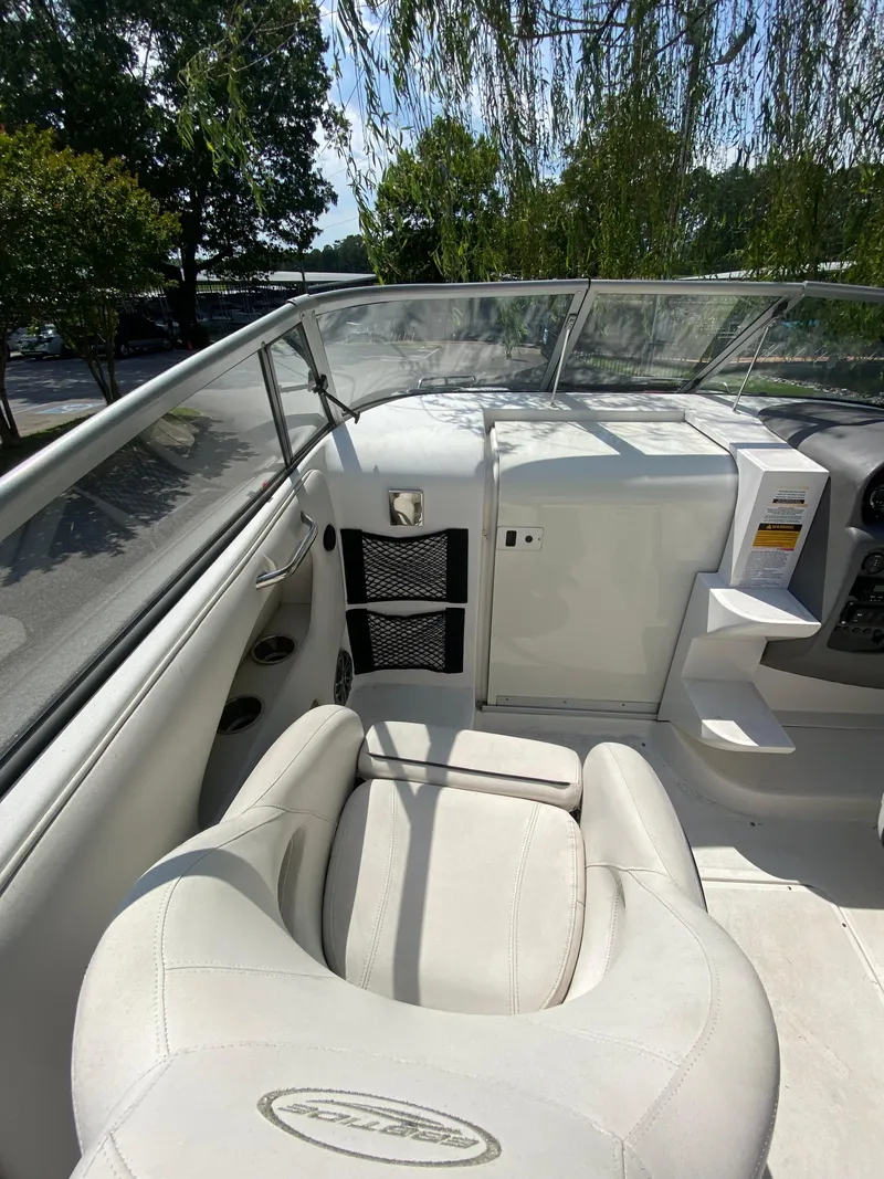Slide: The Image of 2008 Ebbtide 2700 Cuddy Bow Rider interior with white seating and dashboard view. - 7