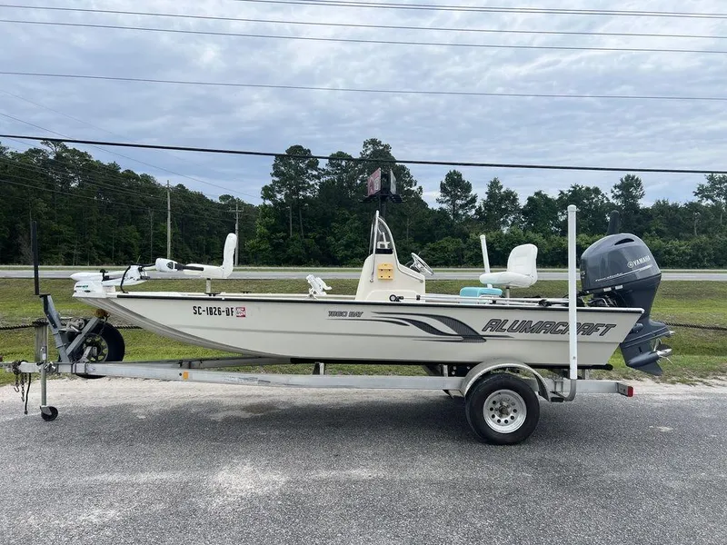Slide: The Image of 2014 Alumacraft 18' All Welds MV 1860 CC boat on trailer, parked outdoors. - 1