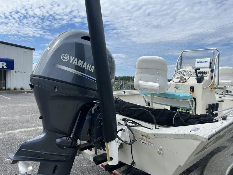 Slide: The Image of 2014 Alumacraft 18' boat with Yamaha motor, parked outdoors. - 13