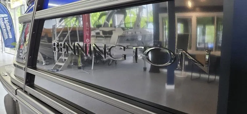 Slide: The Image of 2025 Bennington Q 25 QFBA boat with sleek black exterior in showroom. - 3