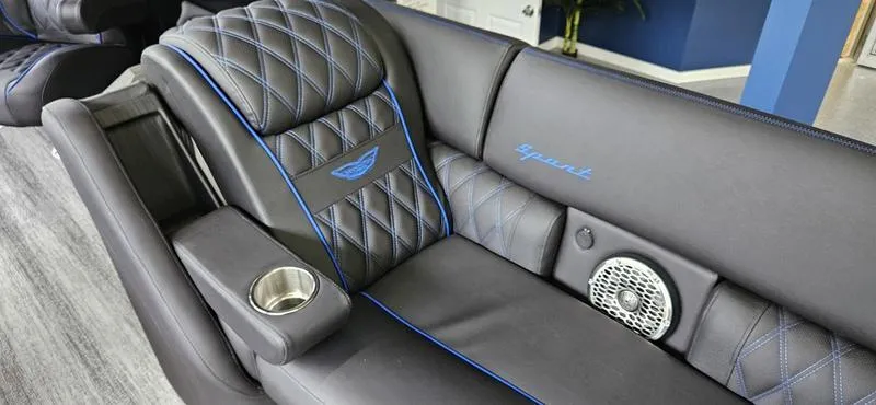 Slide: The Image of Luxurious seating in the 2025 Bennington Q 25 QFBA with blue accents and cup holder. - 7