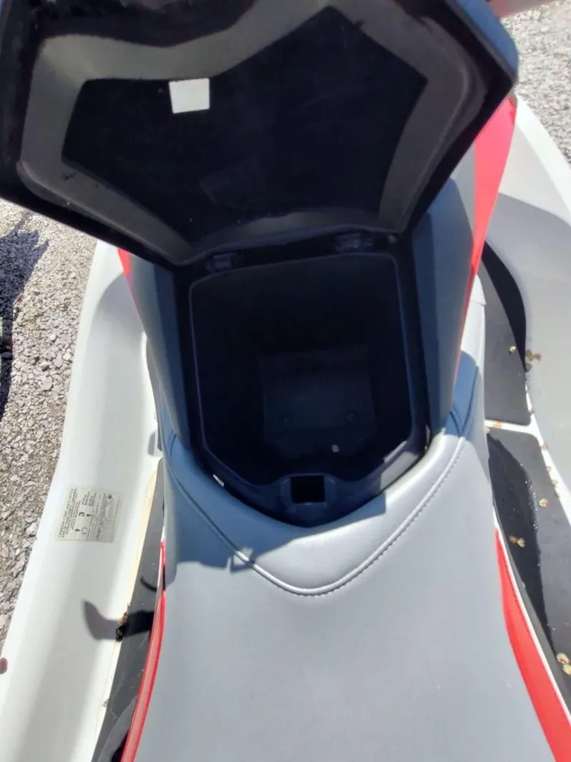 Slide: The Image of 2013 Sea-Doo Wake 155 storage compartment open, showing interior space. - 11
