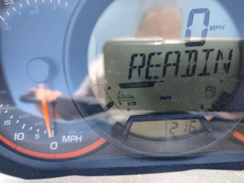 Slide: The Image of Close-up of 2013 Sea-Doo Wake 155 dashboard displaying "READING" and speedometer at 0 MPH. - 4