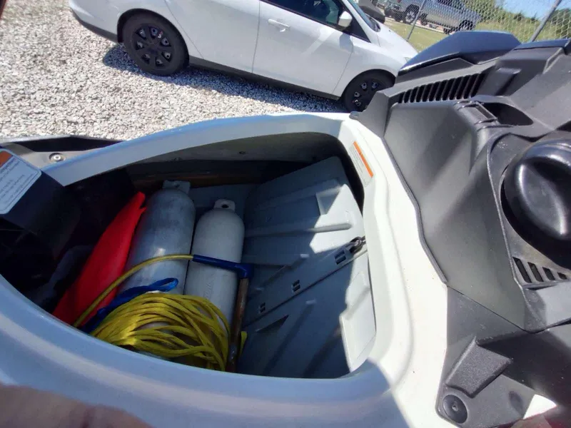 Slide: The Image of Storage compartment of a 2013 Sea-Doo Wake 155 with equipment and supplies. - 6