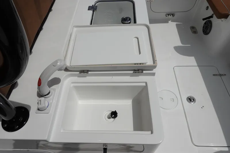 Slide: The Image of 2026 Sea Hunt Gamefish 28 FS livewell with transparent lid and white finish. - 13