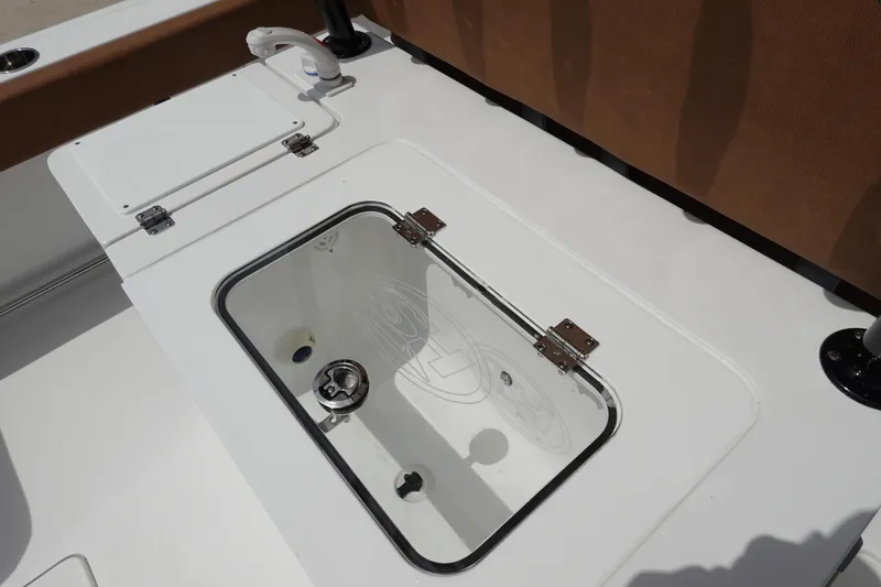 Slide: The Image of 2026 Sea Hunt Gamefish 28 FS boat deck with open storage compartments. - 14