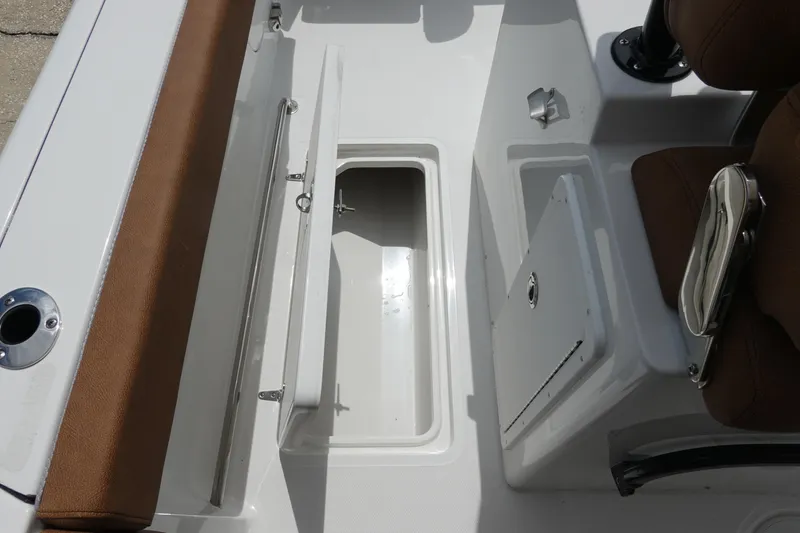 Slide: The Image of 2026 Sea Hunt Gamefish 28 FS storage compartment with open door and latch. - 20