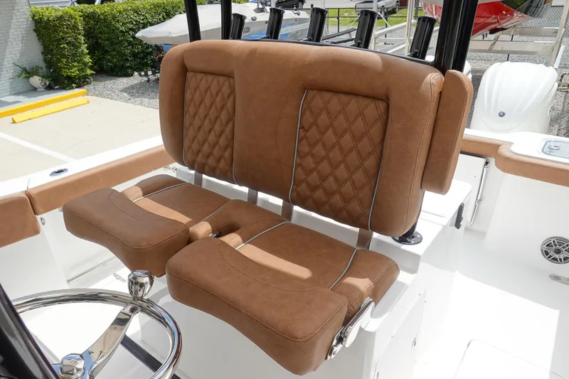 Slide: The Image of 2026 Sea Hunt Gamefish 28 FS boat with luxurious brown seating and steering wheel. - 23