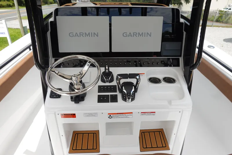 Slide: The Image of 2026 Sea Hunt Gamefish 28 FS boat with brown cushioned seating and diamond stitching. - 24