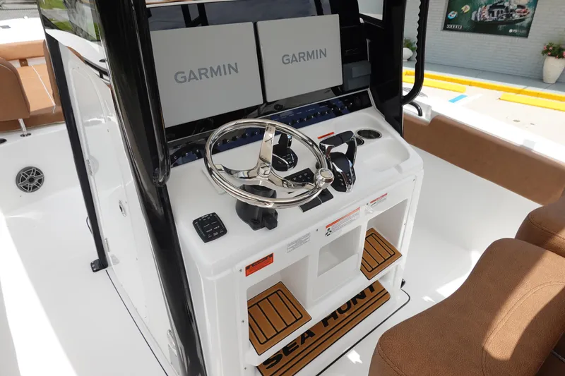 Slide: The Image of 2026 Sea Hunt Gamefish 28 FS helm with dual Garmin displays and modern controls. - 25