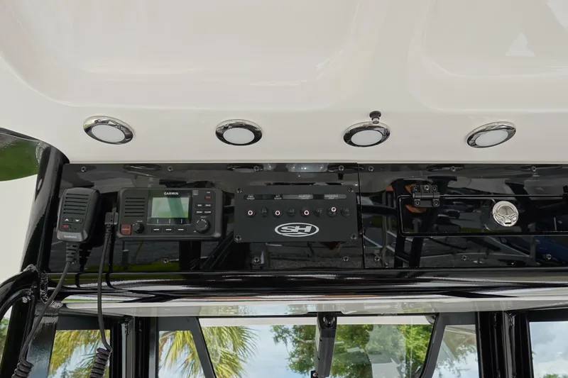 Slide: The Image of 2026 Sea Hunt Gamefish 28 FS dashboard with compass and logo detail. - 28