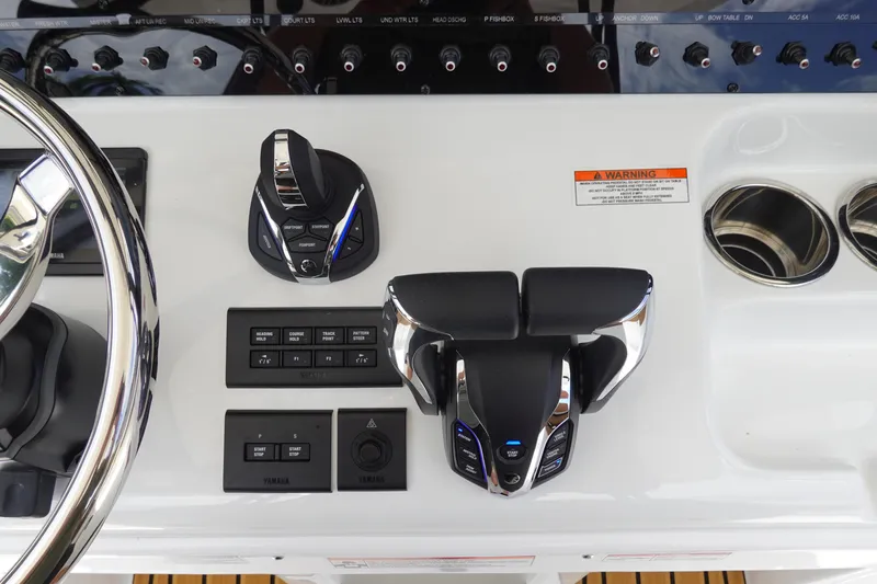 Slide: The Image of 2026 Sea Hunt Gamefish 28 FS dashboard with electronic controls and communication devices. - 29