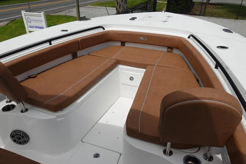Slide: The Image of 2026 Sea Hunt Gamefish 28 FS boat interior with brown diamond-stitched seating. - 31