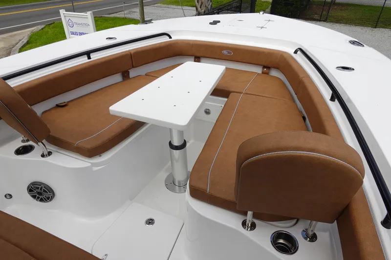 Slide: The Image of 2026 Sea Hunt Gamefish 28 FS boat interior with brown cushioned seating. - 33