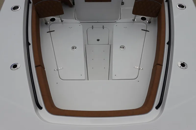 Slide: The Image of 2026 Sea Hunt Gamefish 28 FS boat interior with brown seating and white table. - 34