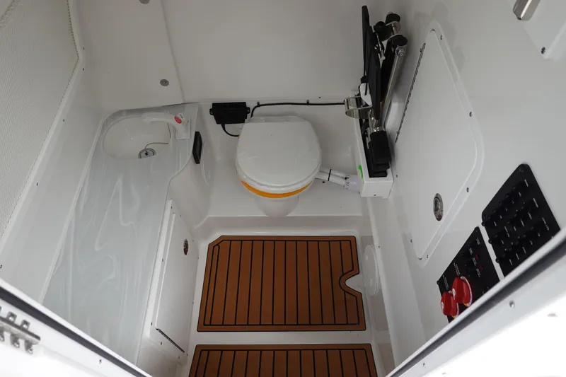 Slide: The Image of 2026 Sea Hunt Gamefish 28 FS boat interior with overhead lighting and glass enclosure. - 40