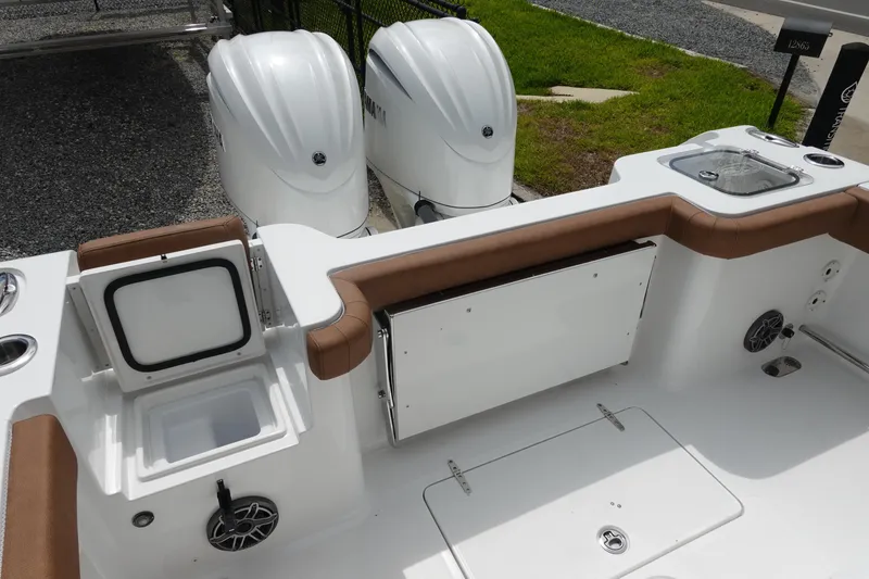 Slide: The Image of 2026 Sea Hunt Gamefish 28 FS boat with brown seating and dual outboard engines. - 9