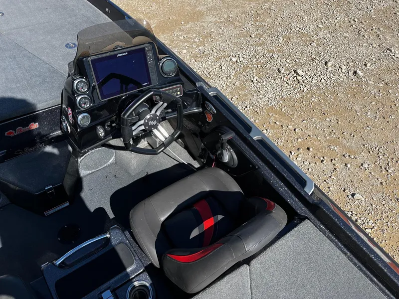Slide: The Image of 2020 Bass Cat Lynx boat cockpit with steering wheel and navigation system. - 11