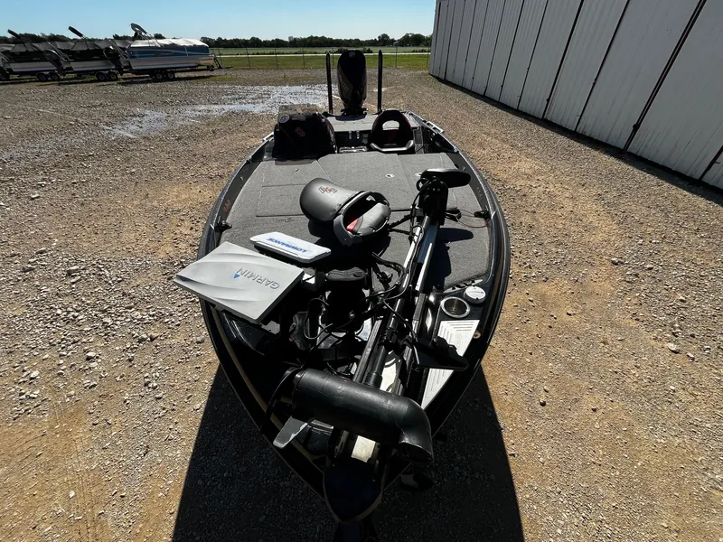 Slide: The Image of 2020 Bass Cat Lynx boat parked on gravel near a storage facility. - 12