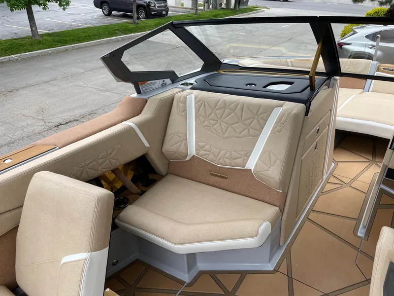 Slide: The Image of 2024 Nautique Super Air Nautique G25 Paragon interior with beige seating and modern design. - 10