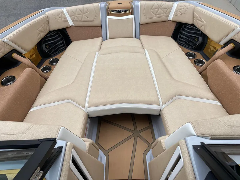 Slide: The Image of 2024 Nautique Super Air Nautique G25 Paragon interior with luxurious beige seating. - 11
