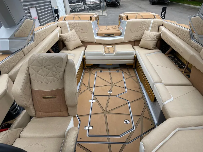 Slide: The Image of 2024 Nautique Super Air Nautique G25 Paragon interior with luxurious beige seating. - 12