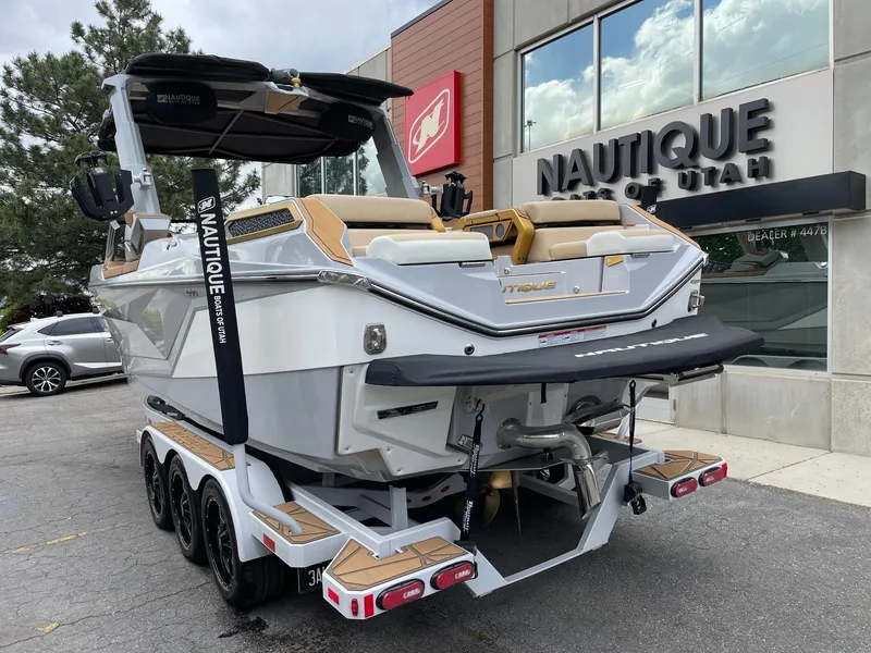 Slide: The Image of 2024 Nautique Super Air Nautique G25 Paragon boat on trailer outside dealership. - 3
