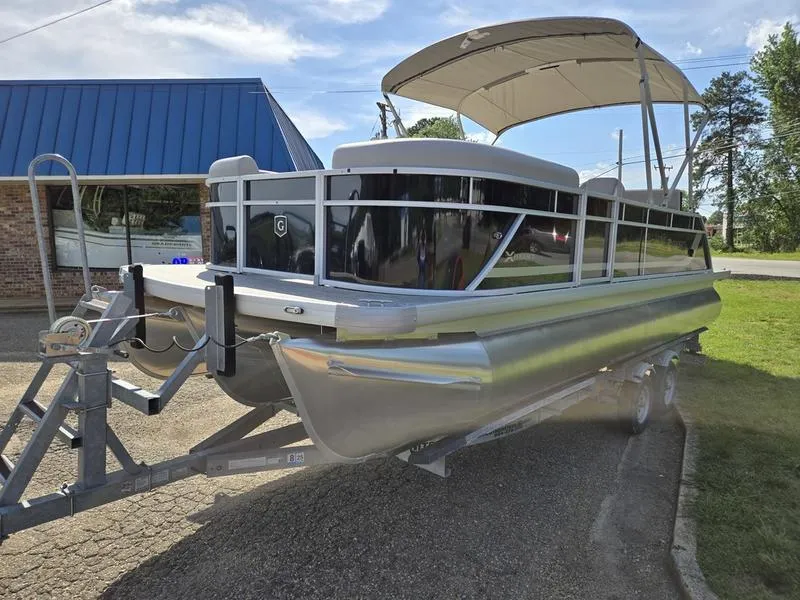 Slide: The Image of 2025 Godfrey Xperience 2286 SFLX Sport Tube pontoon boat on trailer, parked outdoors. - 3