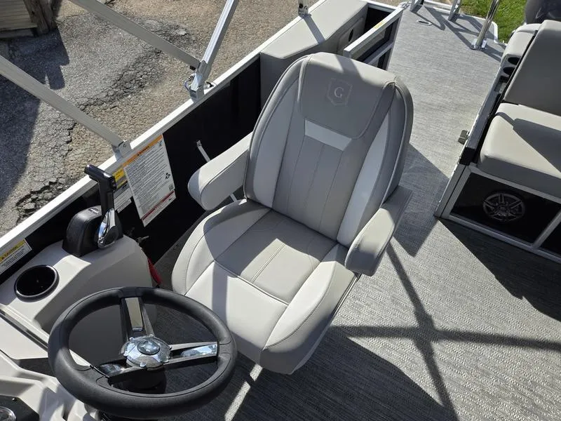 Slide: The Image of Captain's chair and steering wheel on 2025 Godfrey Xperience 2286 SFLX Sport Tube boat. - 9