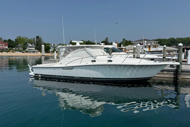 Slide: The Image of 2002 Pursuit 3800 Express yacht docked at a marina on a sunny day. - 14