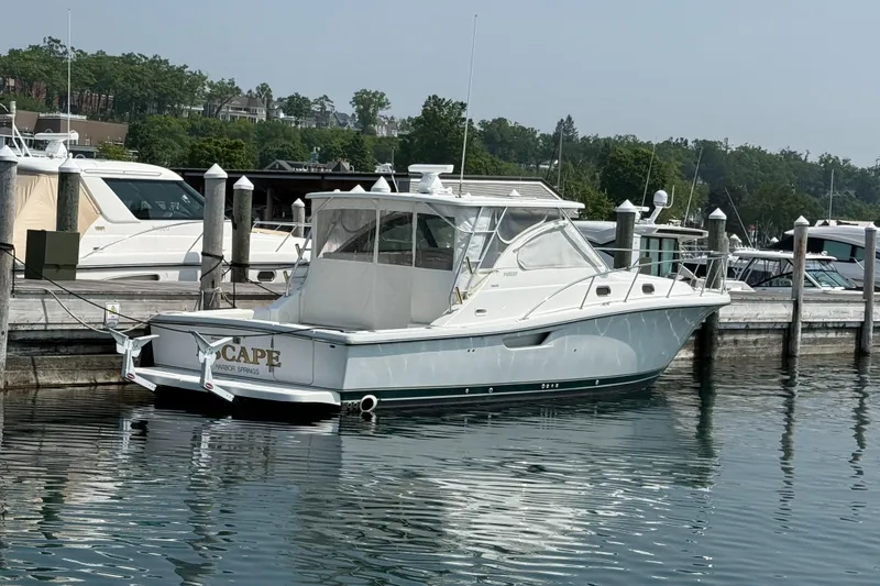Slide: The Image of 2002 Pursuit 3800 Express yacht docked at marina, calm water reflections. - 17
