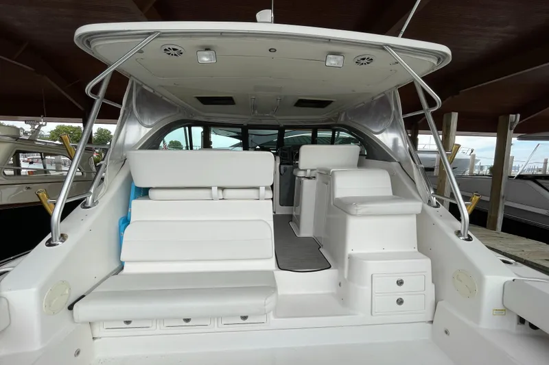 Slide: The Image of 2002 Pursuit 3800 Express boat interior with white seating and helm station. - 18