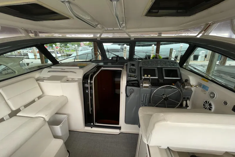 Slide: The Image of 2002 Pursuit 3800 Express boat interior with helm, seating, and navigation equipment. - 24