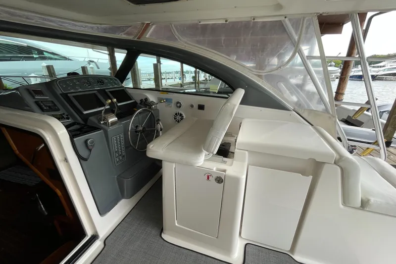 Slide: The Image of 2002 Pursuit 3800 Express boat helm with steering wheel and control panel. - 25