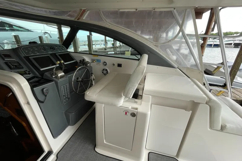 Slide: The Image of 2002 Pursuit 3800 Express boat cockpit with steering wheel and control panel. - 26