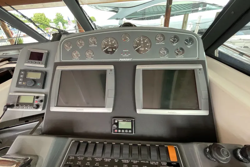 Slide: The Image of Control panel of a 2002 Pursuit 3800 Express boat with dual screens and gauges. - 29