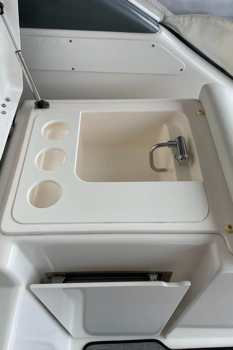 Slide: The Image of 2002 Pursuit 3800 Express boat sink with cup holders and faucet. - 33