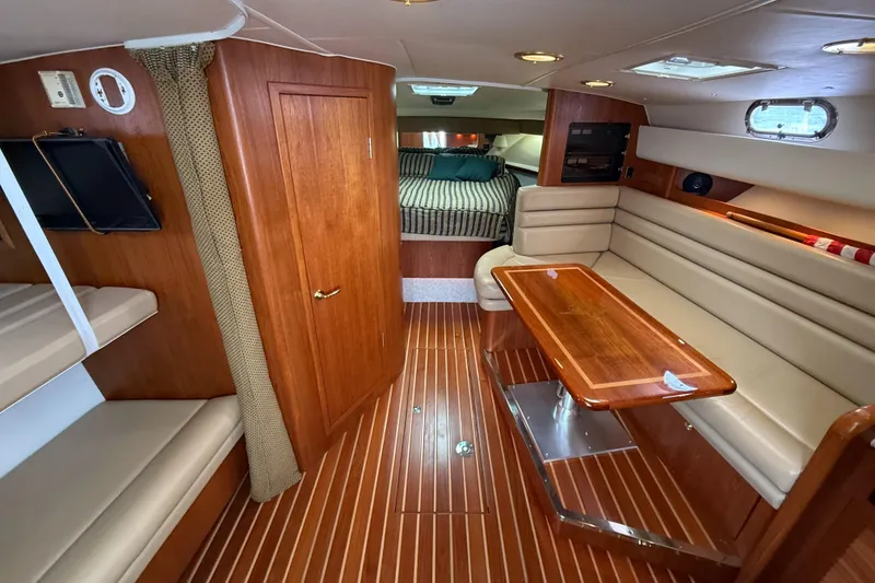 Slide: The Image of Luxurious 2002 Pursuit 3800 Express yacht interior with wood finishes and cozy seating area. - 35