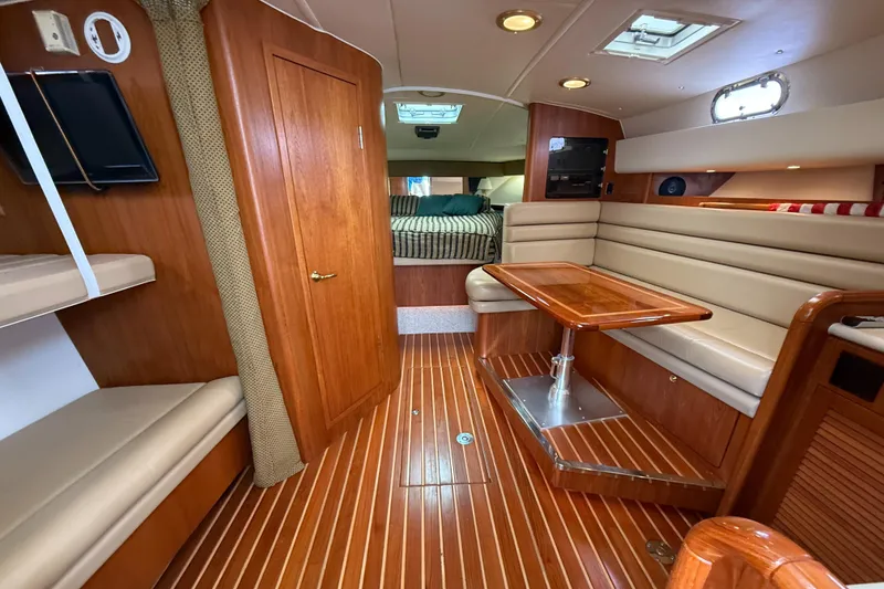 Slide: The Image of Interior of 2002 Pursuit 3800 Express yacht with wood flooring and cozy seating area. - 36