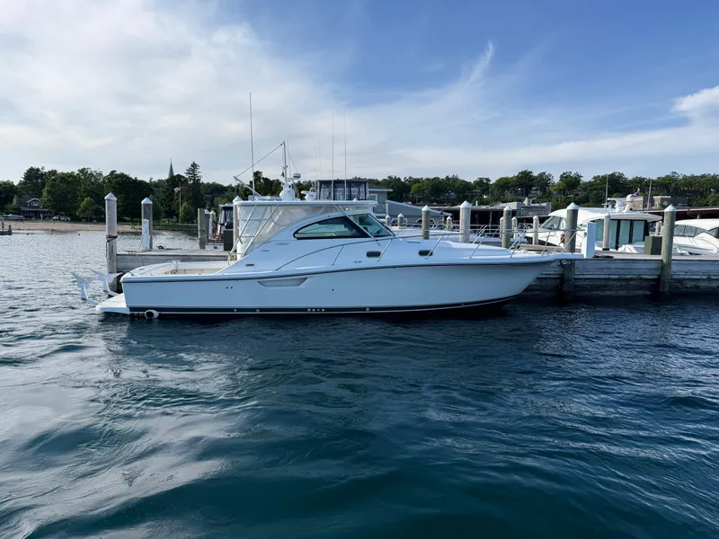 Slide: The Image of 2002 Pursuit 3800 Express yacht docked at marina, calm water, clear sky. - 4