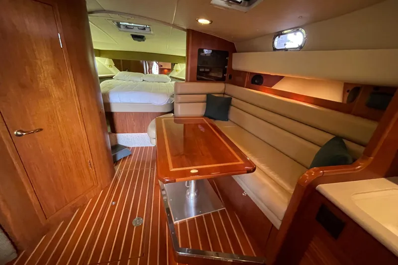 Slide: The Image of Interior of 2002 Pursuit 3800 Express yacht with cozy seating and wooden finishes. - 40