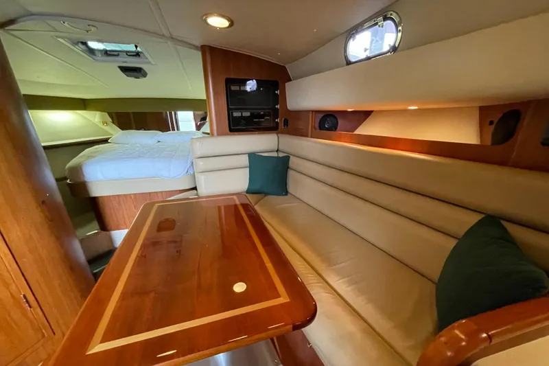 Slide: The Image of 2002 Pursuit 3800 Express yacht interior with cozy seating and elegant wood finishes. - 46