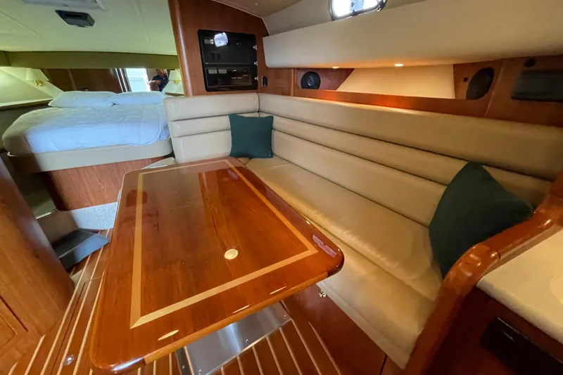 Slide: The Image of Interior of 2002 Pursuit 3800 Express yacht with elegant seating and wooden table. - 47