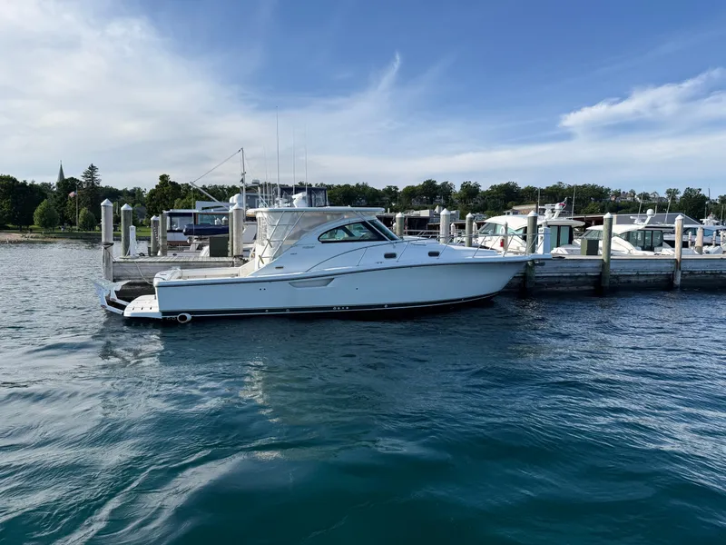 Slide: The Image of 2002 Pursuit 3800 Express yacht docked at marina, calm water, clear sky. - 5