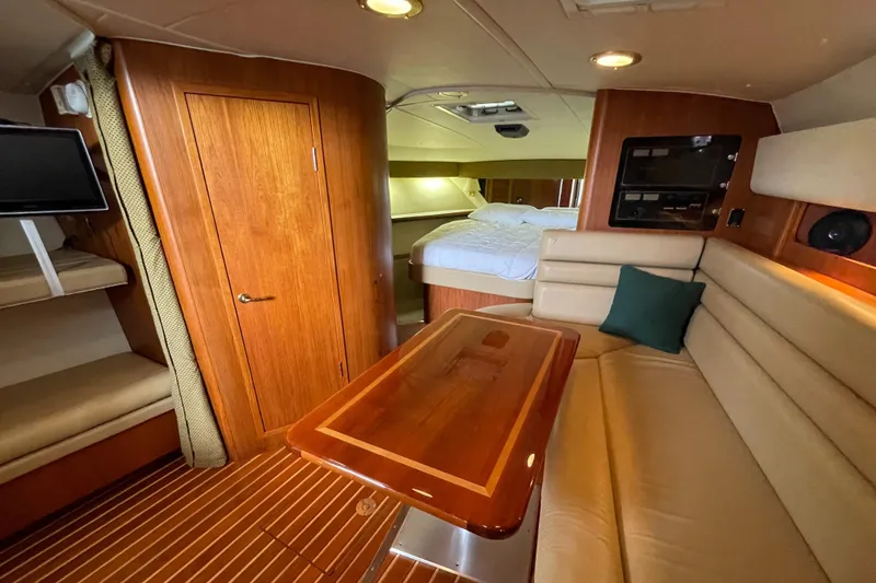 Slide: The Image of Luxurious interior of a 2002 Pursuit 3800 Express yacht with wood finishes and cozy seating. - 50