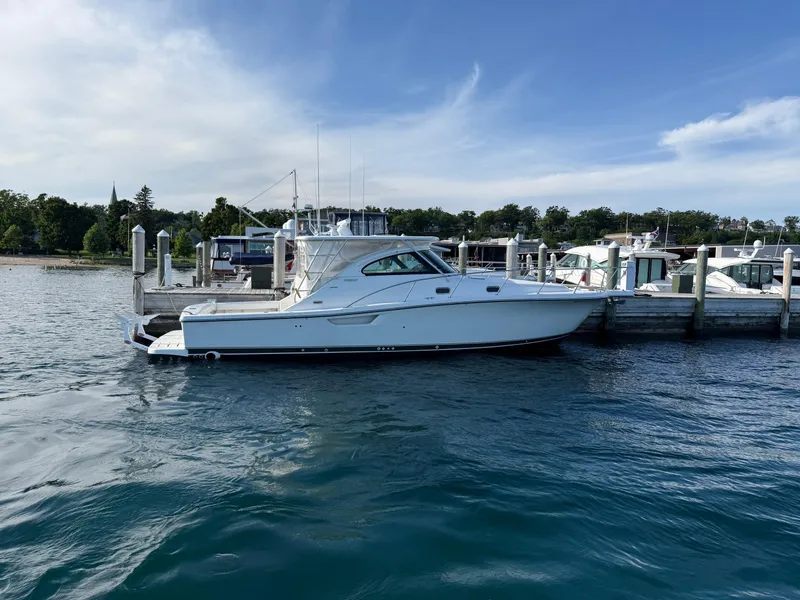 Slide: The Image of 2002 Pursuit 3800 Express yacht docked at a marina on a sunny day. - 6