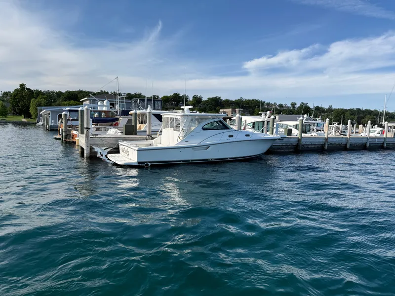 Slide: The Image of 2002 Pursuit 3800 Express yacht docked at a marina on a sunny day. - 7