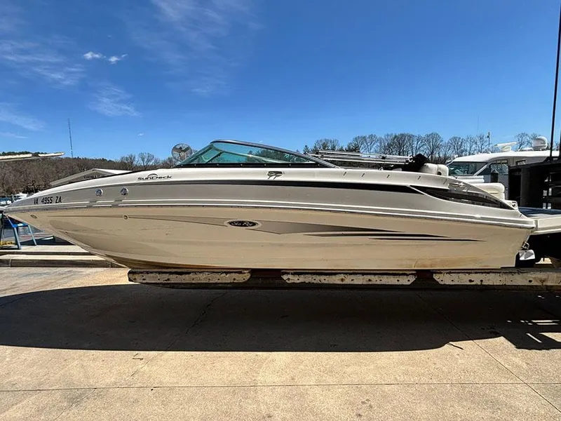 The Image of 2013 Sea Ray 240 Sundeck boat on trailer under clear blue sky. - 1