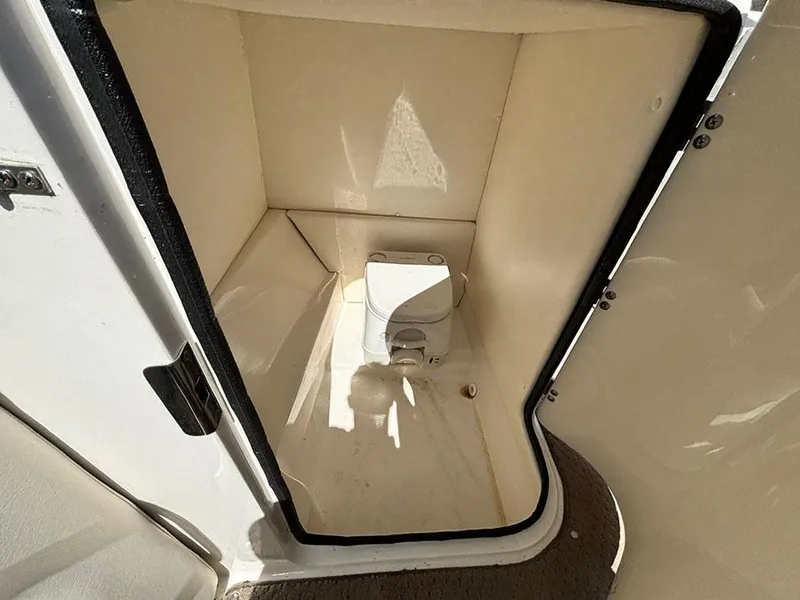 Slide: The Image of 2013 Sea Ray 240 Sundeck boat interior with compact toilet compartment. - 10